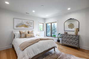 Bedroom with light hardwood / wood-style flooring