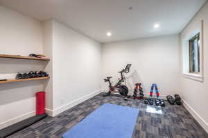 Workout room with dark colored carpet