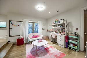 Interior space with a wealth of natural light and light hardwood / wood-style floors