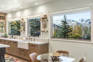 Kitchen featuring light stone countertops, a mountain view, sink, and light hardwood / wood-style flooring