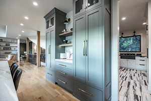 Kitchen with light stone countertops and light hardwood / wood-style flooring