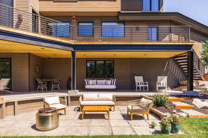View of patio / terrace featuring a balcony and an outdoor living space with a fire pit