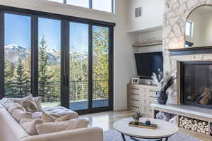 Living room featuring a premium fireplace, a mountain view, and light hardwood / wood-style floors