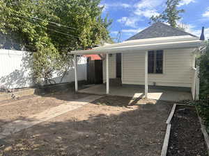 Rear view of property featuring a covered patio area