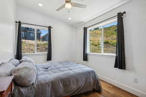 Bedroom featuring lofted ceiling, ceiling fan, and wood-type flooring