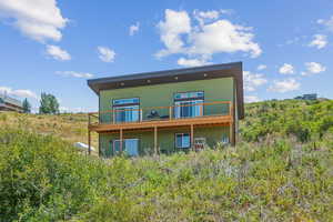 Rear view of house featuring a balcony