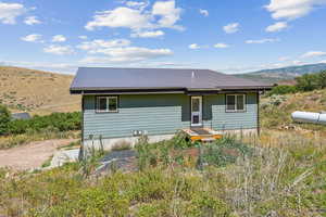 Back of property with a mountain view