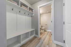 Mudroom featuring light wood-type flooring and a textured ceiling