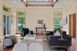 Large windows that let in plenty of natural light, which enhances the room's openness and connects it to the outdoors