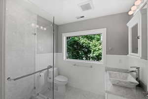 Sleek design with a large window and walk in shower