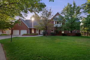 All brick home exudes a sense of grandeur and timeless elegance with full landscaping