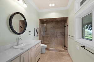 The walk-in tile shower and the primary bathroom’s overall design create a luxurious and inviting space. The combination of high-quality materials, elegant fixtures, and thoughtful design elements ensures that the bathroom feels like a personal retreat.