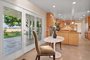 A breakfast dining area with glass doors is a bright and inviting space designed to offer a pleasant, casual dining experience.