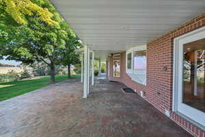 Enjoy watching the rain come down from this covered back patio with valley and mountain views.