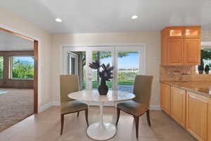 A breakfast dining area with glass doors is a bright and inviting space designed to offer a pleasant, casual dining experience.