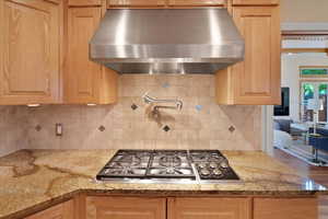 Traditional kitchen featuring stainless steel appliances and a pot filler, the blend of modern convenience with classic design creates a unique and functional space