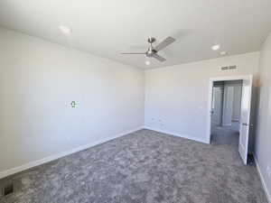 Spare room featuring ceiling fan and carpet floors