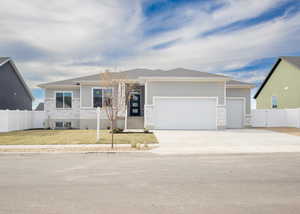 View of front of home with a garage and a front yard