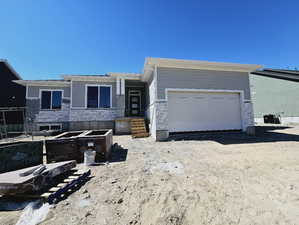 View of front facade with a garage and central AC unit