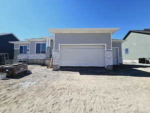 View of front of property with cooling unit and a garage