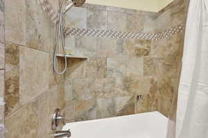 Interior space featuring shower / bath combination with curtain