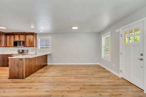 Kitchen featuring kitchen peninsula, and stainless steel appliances