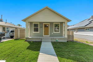 Bungalow-style house featuring a porch and a front lawn