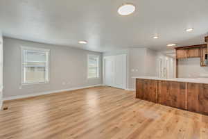 Unfurnished living room with plenty of natural light, 2 tone paint, and LVP flooring