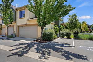 View of front of house with a garage and central air condition unit