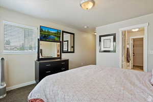 Carpeted bedroom with a textured ceiling