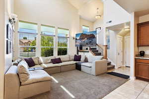 Tiled living room with high vaulted ceiling