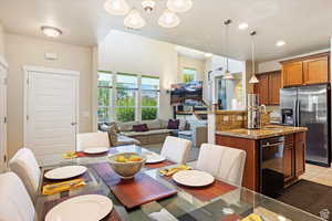 Dining space with an inviting chandelier, light tile patterned floors, and sink