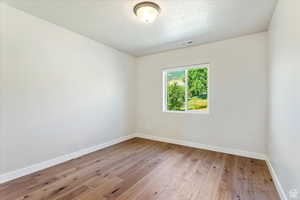 Empty room featuring wood-type flooring