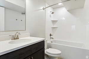 Full bathroom featuring vanity, toilet, and shower / tub combination