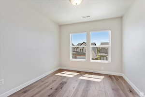 Spare room featuring light hardwood / wood-style floors