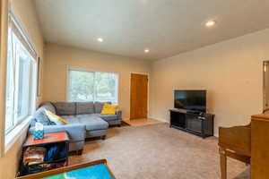 Living room with a textured ceiling and carpet flooring