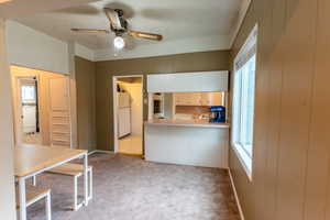 Kitchen featuring light carpet, plenty of natural light, ceiling fan, and white fridge