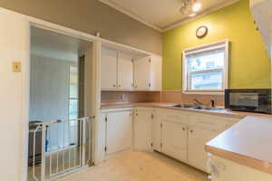 Kitchen with sink and white cabinets