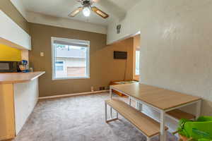 Dining space featuring light colored carpet and ceiling fan