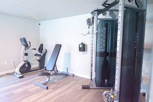 Exercise area featuring hardwood / wood-style floors