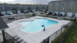 View of pool with a mountain view and a patio area