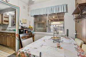 Dining area with light tile patterned floors and sink