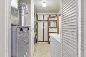 Laundry room with gas water heater, independent washer and dryer, and heating unit