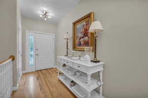 Entrance foyer with light wood-type flooring