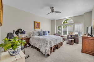 Bedroom featuring ceiling fan and carpet floors