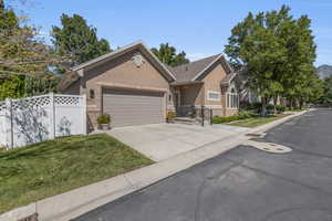 View of front of home with a garage and a front lawn