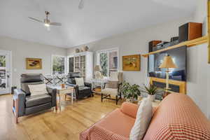 Living room featuring ceiling fan and light hardwood / wood-style floors