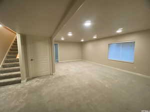 Basement with light colored carpet