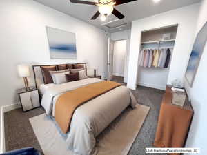 Carpeted bedroom with ceiling fan and a closet