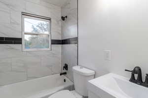 Kolasus white tile, subway tile and niche, with black trim and finishes. New toilet and vanity